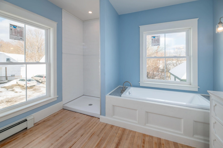 blue bathroom with shower area and bathtub